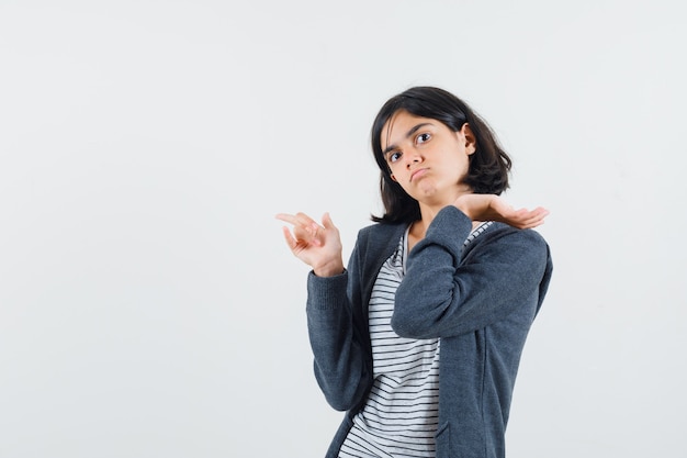 Free Photo | Little girl pointing aside in t-shirt, jacket and looking ...