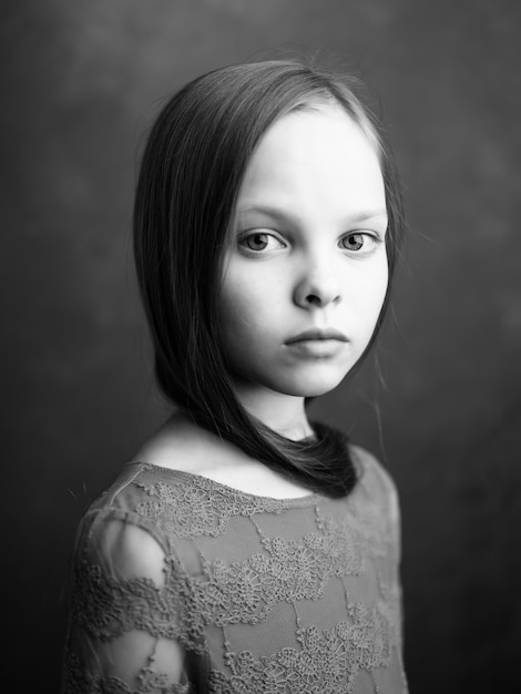 Premium Photo | Little girl posing long hair closeup black and white photo