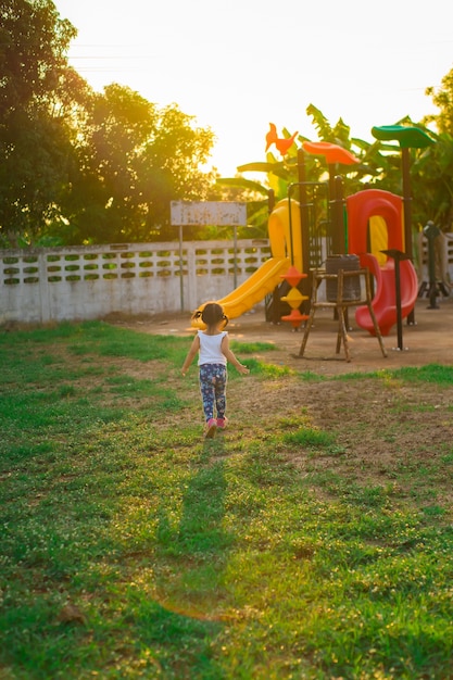 Premium Photo | Little girl run to playground in the evening