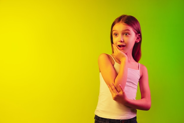 Premium Photo | Little girl's portrait isolated on neon wall