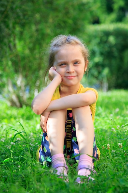 Premium Photo | Little girl sitting in the grass