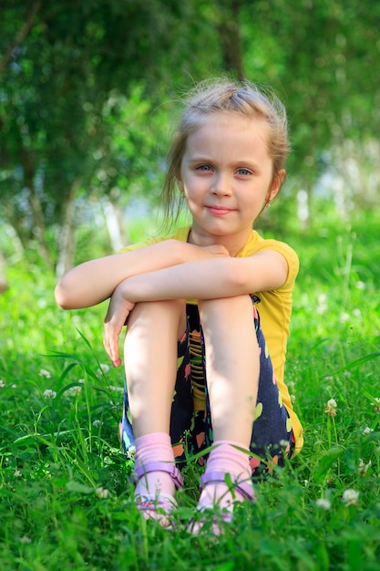 Premium Photo | Little girl sitting in the grass