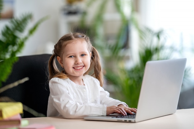 Premium Photo | Little girl using digital laptop e-learning concept ...