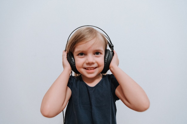 Premium Photo | Little girl with big headphones at home