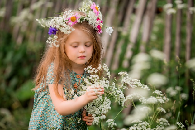 Premium Photo | Little girl with a wreath of flowers on her head for a walk