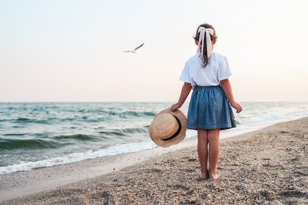 Premium Photo | Little lady girl is at sea beach in summer vacation ...