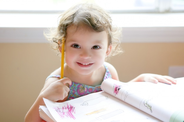 Little Toddler Girl Writing At School Desk Premium Photo