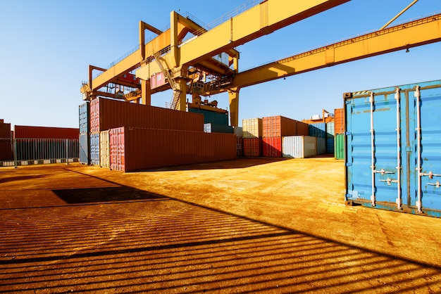 Loading and unloading of containers in the port on a bright sunny day Premium Photo