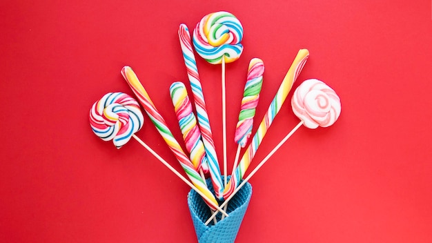 Lollipops and candy sticks in cone Free Photo