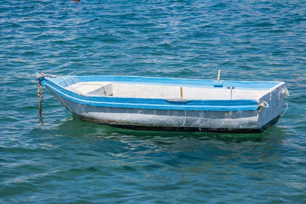 Premium Photo A Lonely Boat In The Harbor Moored In The Water