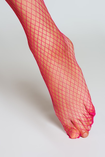 Download Long muscular female leg in sexy pink fishnet tights ...