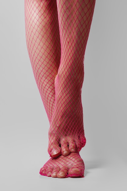 Download Long muscular female legs in sexy pink fishnet tights ...
