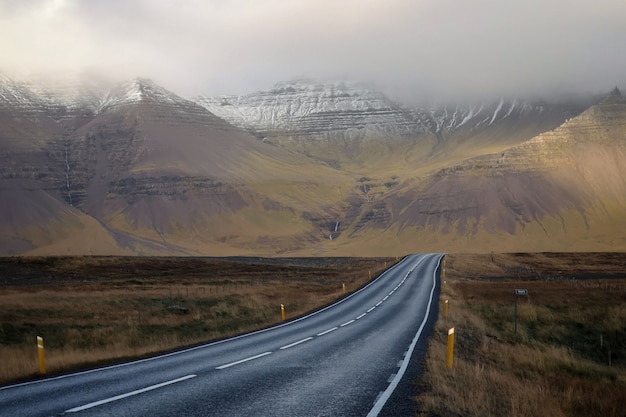 Free Photo | Long narrow road with beautiful hills and mountains ...