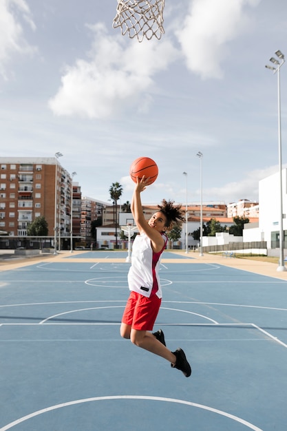 girl dunking basketball