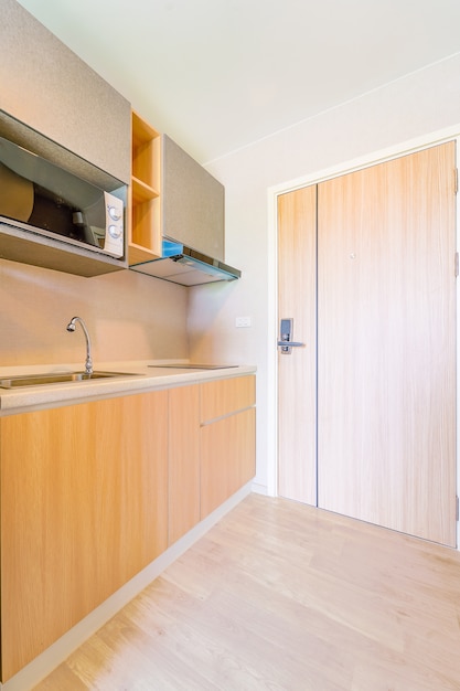 Premium Photo | Looking into a small empty kitchen with stove, fridge ...