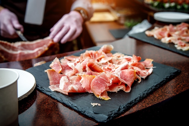 Premium Photo Aƒaƒa Aƒaƒa A A Aƒaƒa A Aƒa A A Lose Up Of Small Thin Slices Of Spanish Jamonon Black Cutting Board