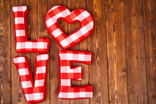 premium-photo-love-word-of-plush-red-letters-on-wood-background