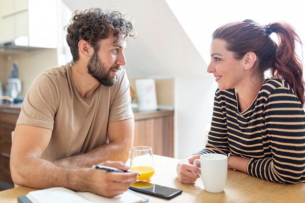 Lovely couple talking in the kitchen | Free Photo