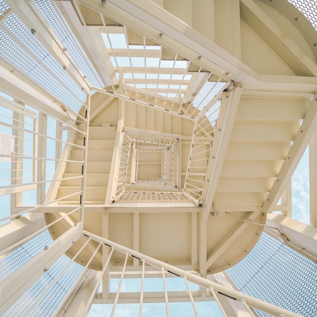 Low angle shot of a metal staircase going up | Free Photo