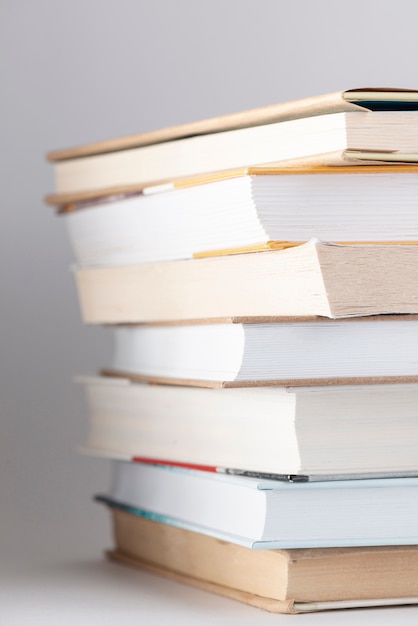 Free Photo | Low angle stack of books with glasses on top