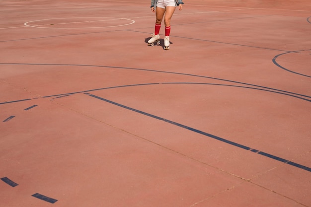 Free Photo | Low angle view of female skater skating on court