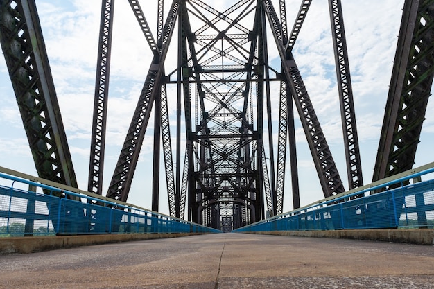 Premium Photo | Low angle view of road and truss bridge above water