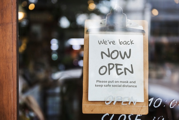 ‘we’re back, now open’ cafe sign after covid-19 pandemic Free Photo