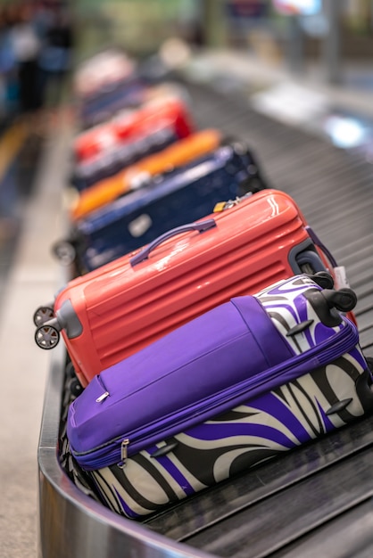 Premium Photo | Luggage on conveyor belt at the airport