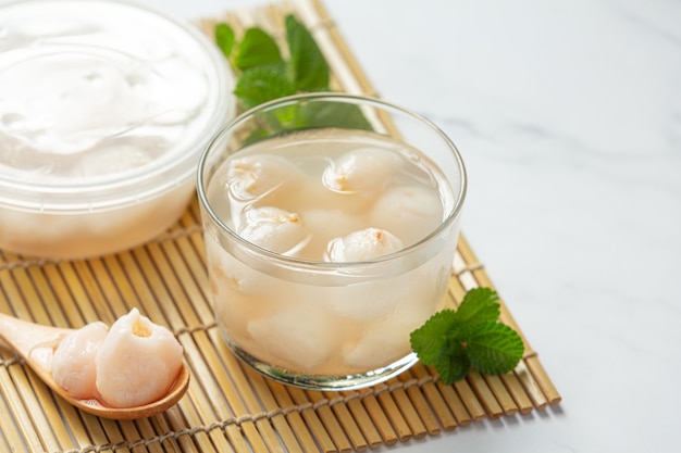 Lychee in syrup on white surface Free Photo