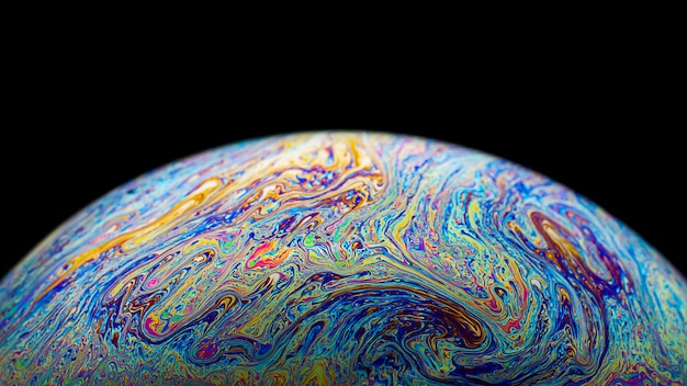 Macro picture of half soap bubble look like planet in space Premium Photo