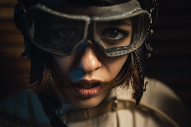 Premium Photo  Mad woman in a straitjacket and a pilot helmet 