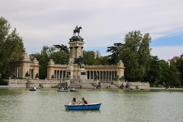 Premium Photo | Madrid spain people riding small boats at parque del ...