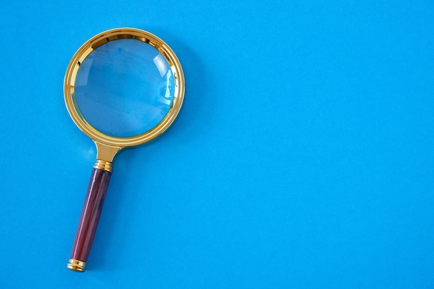 Premium Photo | Magnifying glass on a bright blue background.