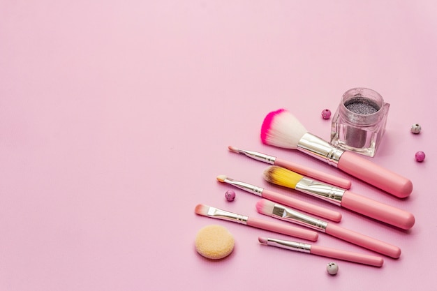 Premium Photo | Makeup cosmetic set on pink background