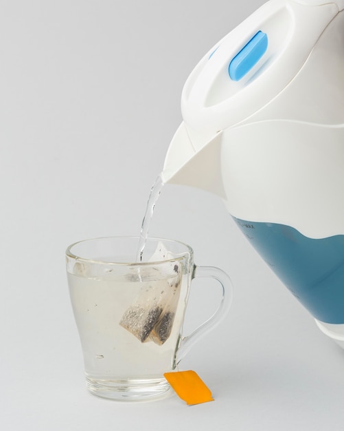 Free Photo Making a tea with hot water from electric kettle