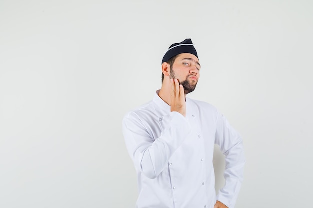 Free Photo | Male chef touching at his beard in white uniform and ...