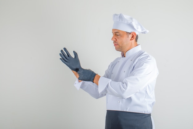 Free Photo Male Chef In Uniform Apron And Hat Wearing Gloves And Looking Careful