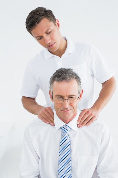 Premium Photo | Male chiropractor massaging patients neck