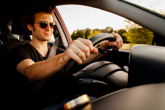 Male driving car on road Photo | Free Download