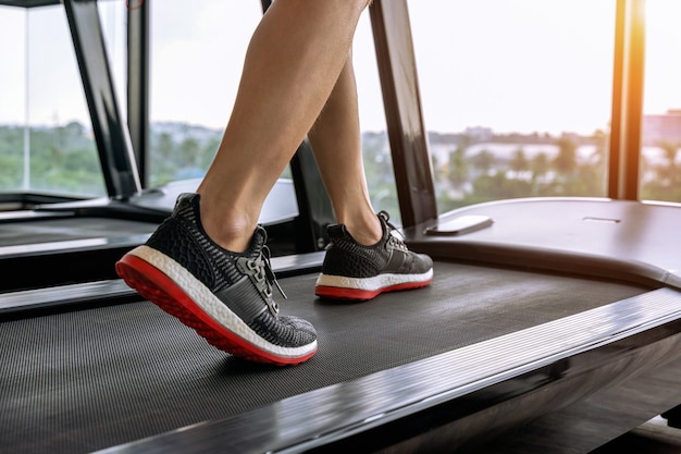 Male feet in sneakers running on the treadmill at the gym. exercise concept. Free Photo