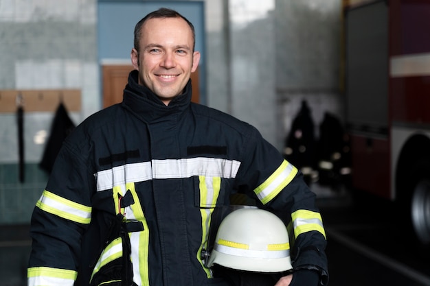 Premium Photo | Male firefighter posing with suit and helmet