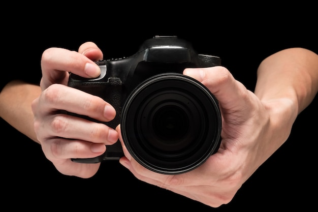 Male hand holding a digital camera on a black background. | Premium Photo