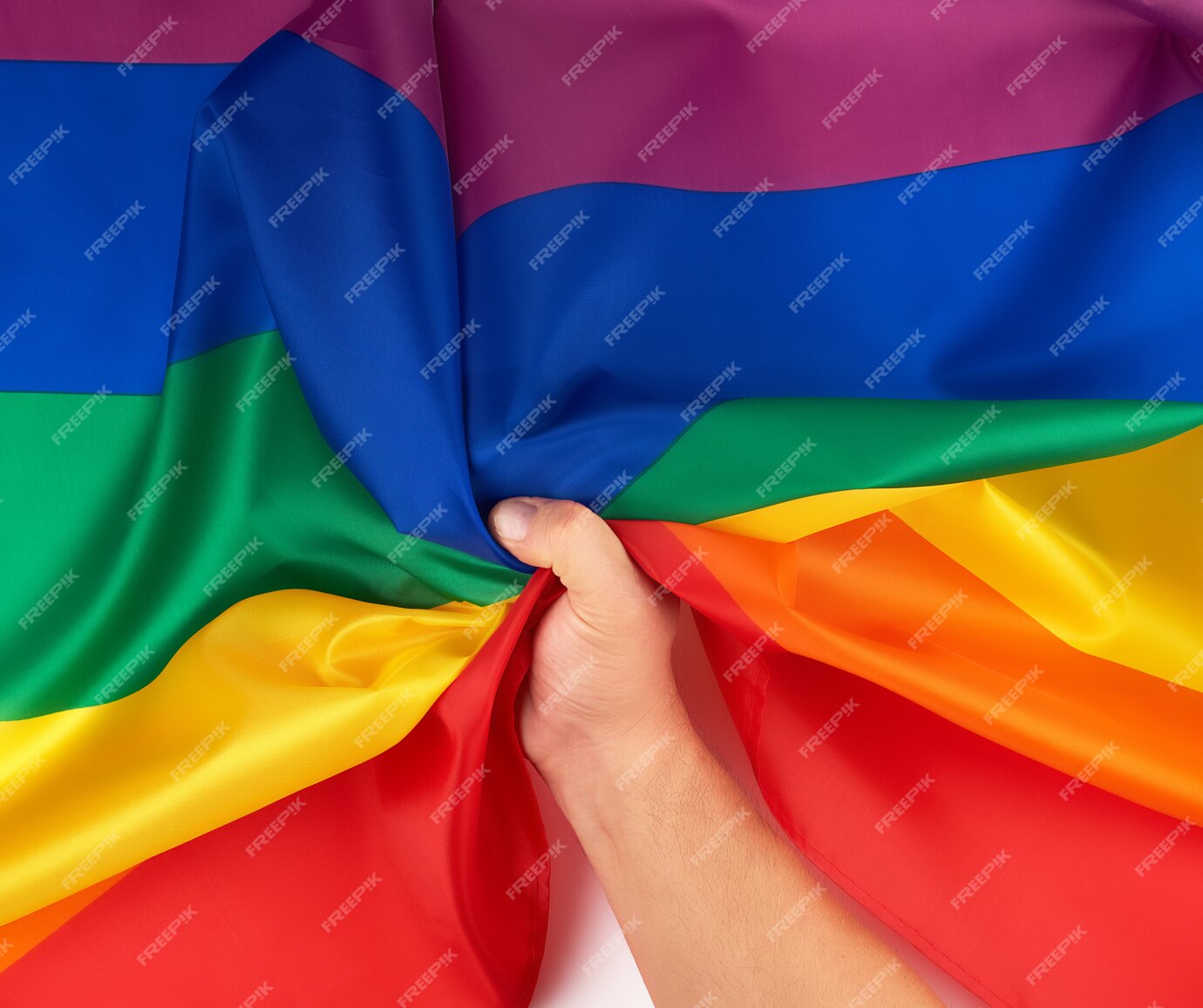 premium-photo-male-hand-holds-a-rainbow-flag-a-symbol-of-the-lgbt