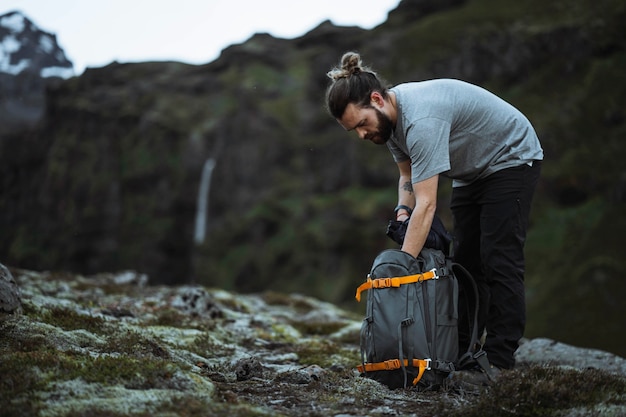 Premium Photo | Male hiker packing his bag