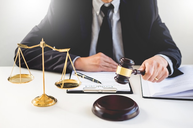 Premium Photo | Male lawyer in a courtroom striking the gavel