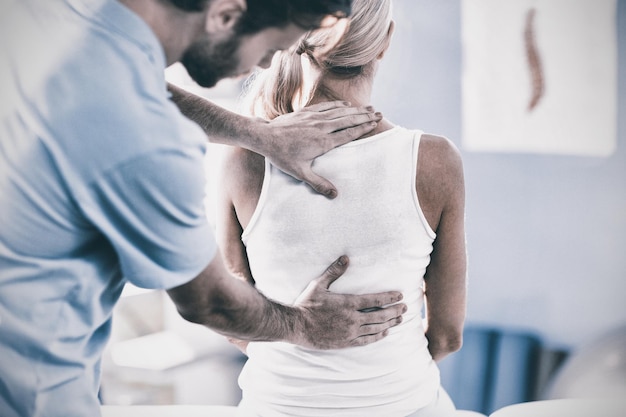 Premium Photo Male Physiotherapist Giving Back Massage To Female Patient