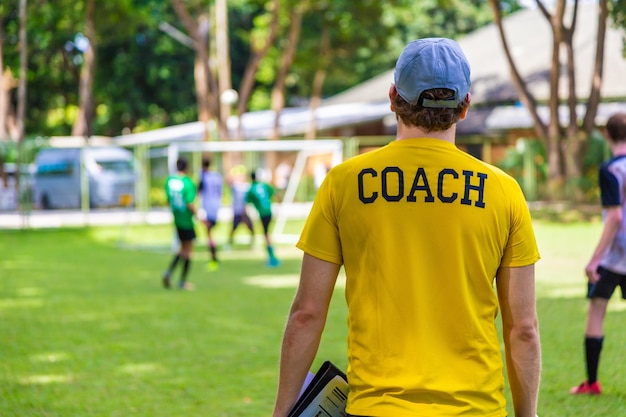 Premium Photo | Male Soccer Or Football Coach Standing On The Sideline ...