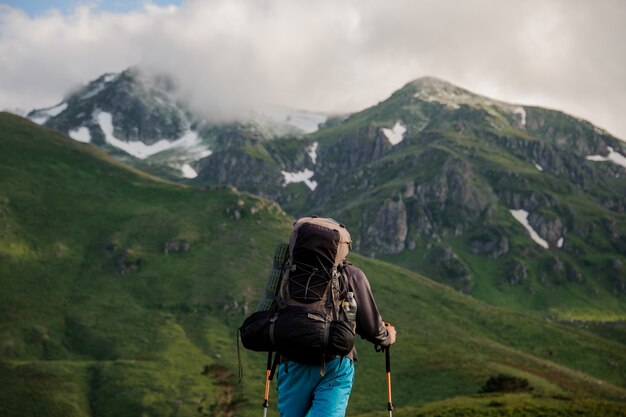 Premium Photo | Male tourist stands in front of mountains