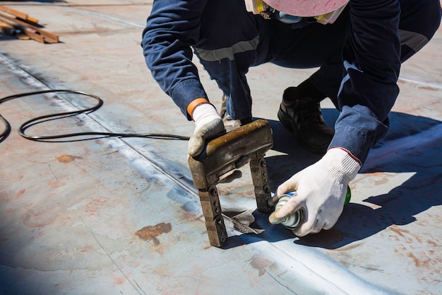 Premium Photo | Male worker test steel tank butt weld carbon bottom ...