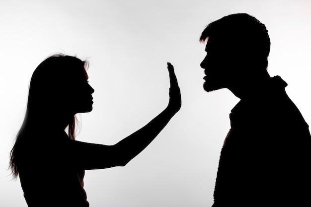 Premium Photo | Man abusing woman, silhouette on a white background.